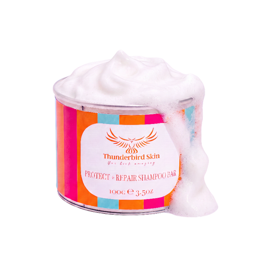 A tin of Thunderbird Skin Protect + Repair Shampoo Bar, filled with white shampoo bar and overflowing with thick white foam, set against a solid white background.