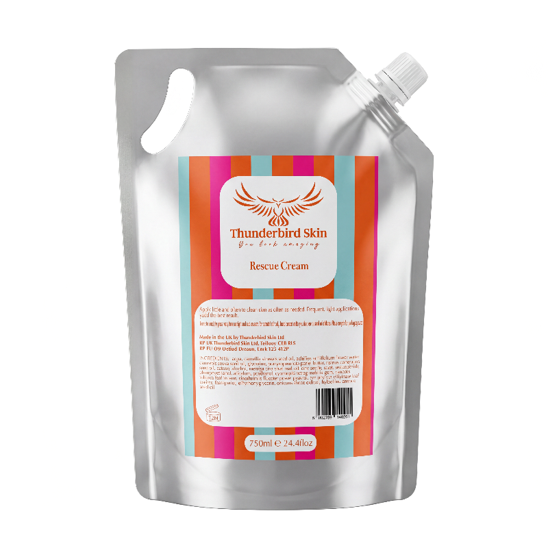 A silver resealable stand-up pouch of Thunderbird Skin Rescue Cream with a colorful striped label, isolated on a white background.