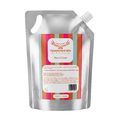 A silver resealable stand-up pouch of Thunderbird Skin Rescue Cream with a colorful striped label, isolated on a white background.